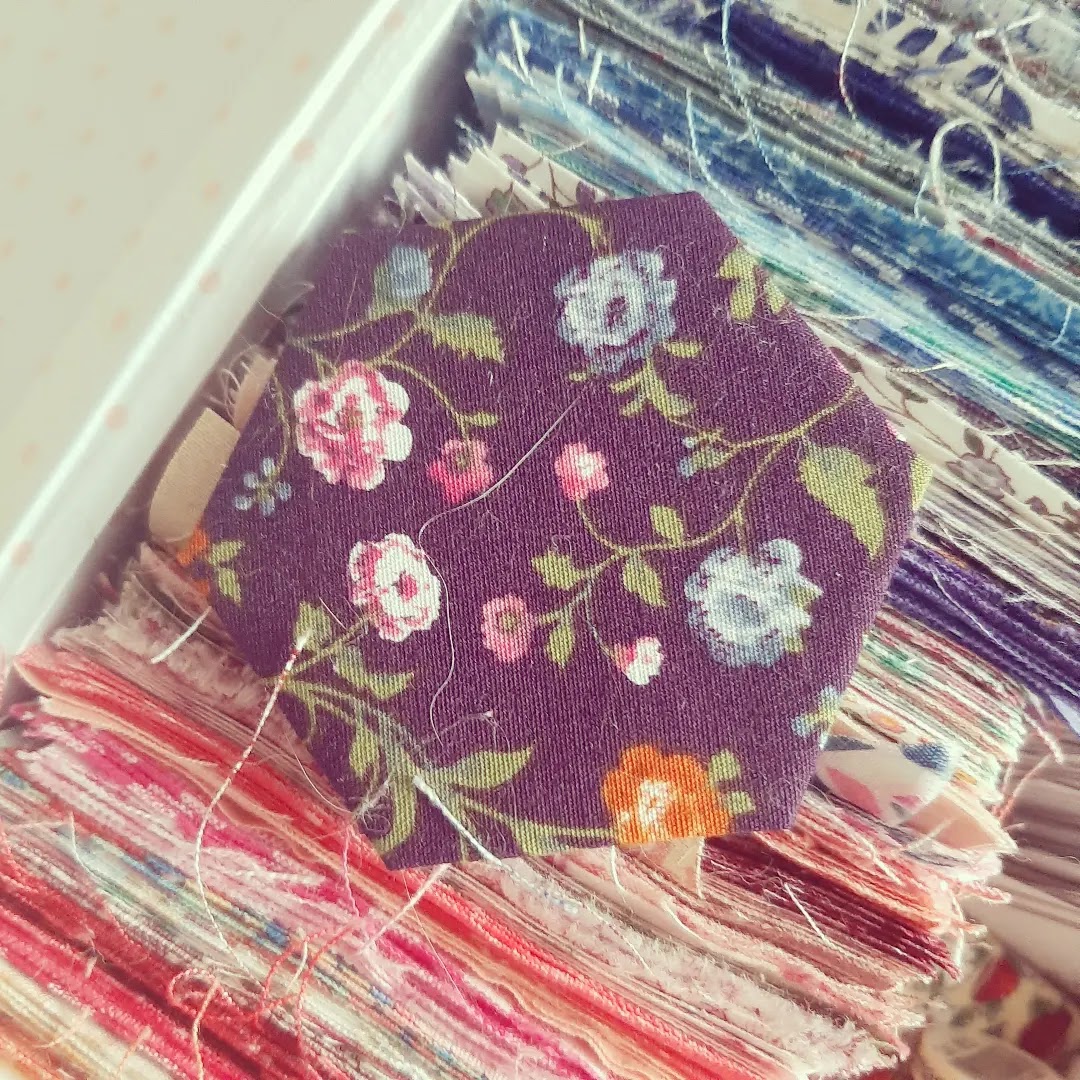 Squares of cotton fabric with fabric hexagon laying on top