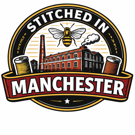 circular logo with banner across bottom saying 'Stitched in Manchester'. Cotton mill, Manchester bee and cotton reels included.